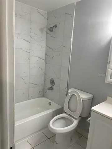 a bathroom with a toilet and a bathtub