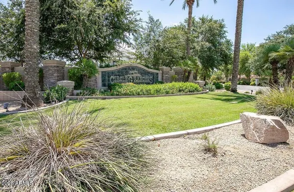 a garden with trees in front of it