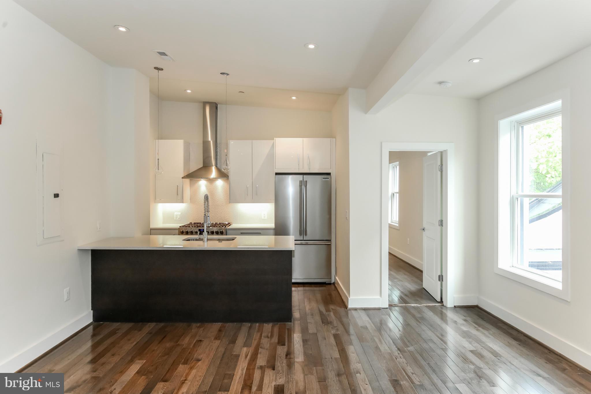 462 Ridge Street Northwest, Unit 3 Washington, DC 20001 - Photo 2 of 20 a view of kitchen with wooden floor and electronic appliances
