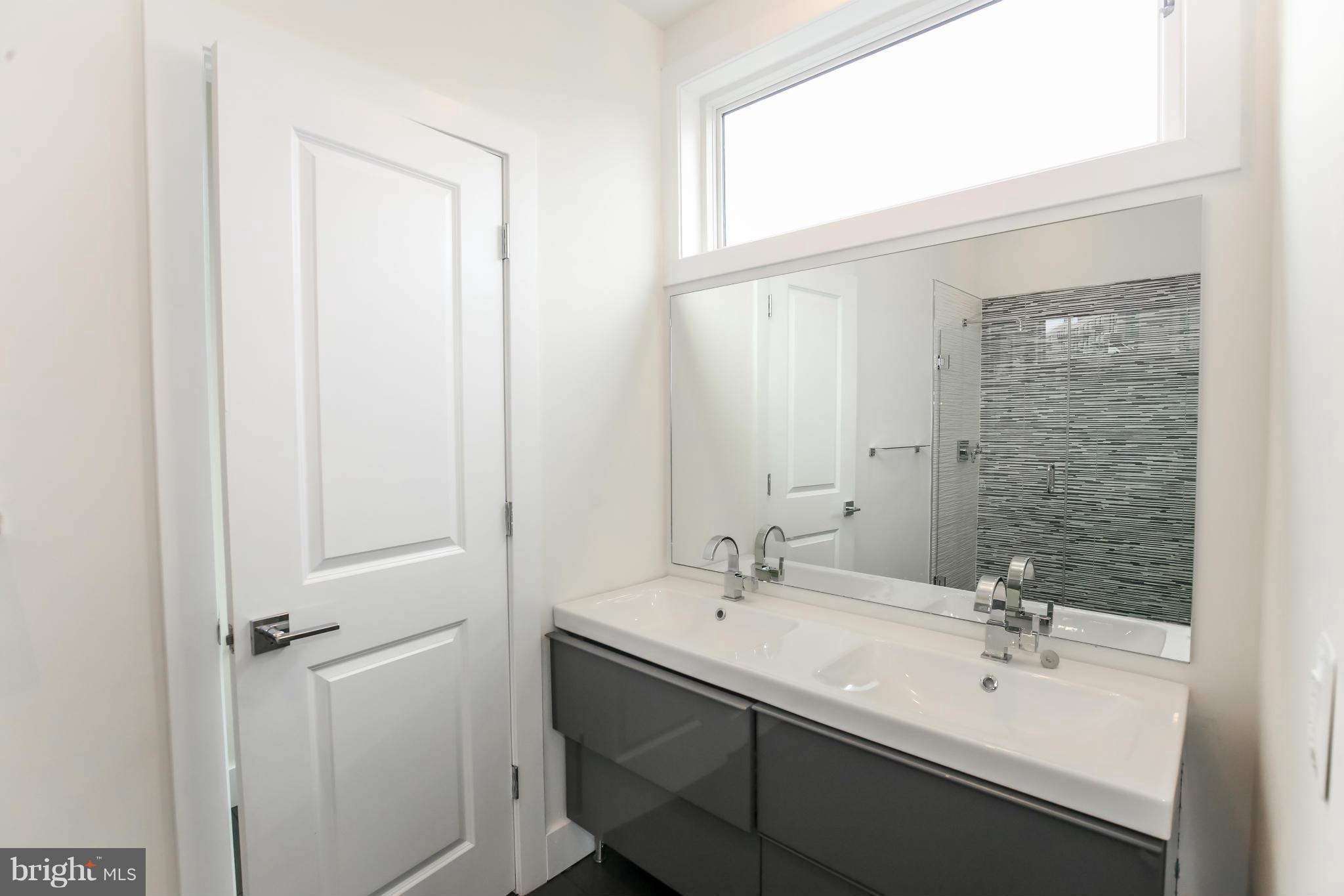 462 Ridge Street Northwest, Unit 3 Washington, DC 20001 - Photo 12 of 20 a bathroom with a sink and a mirror