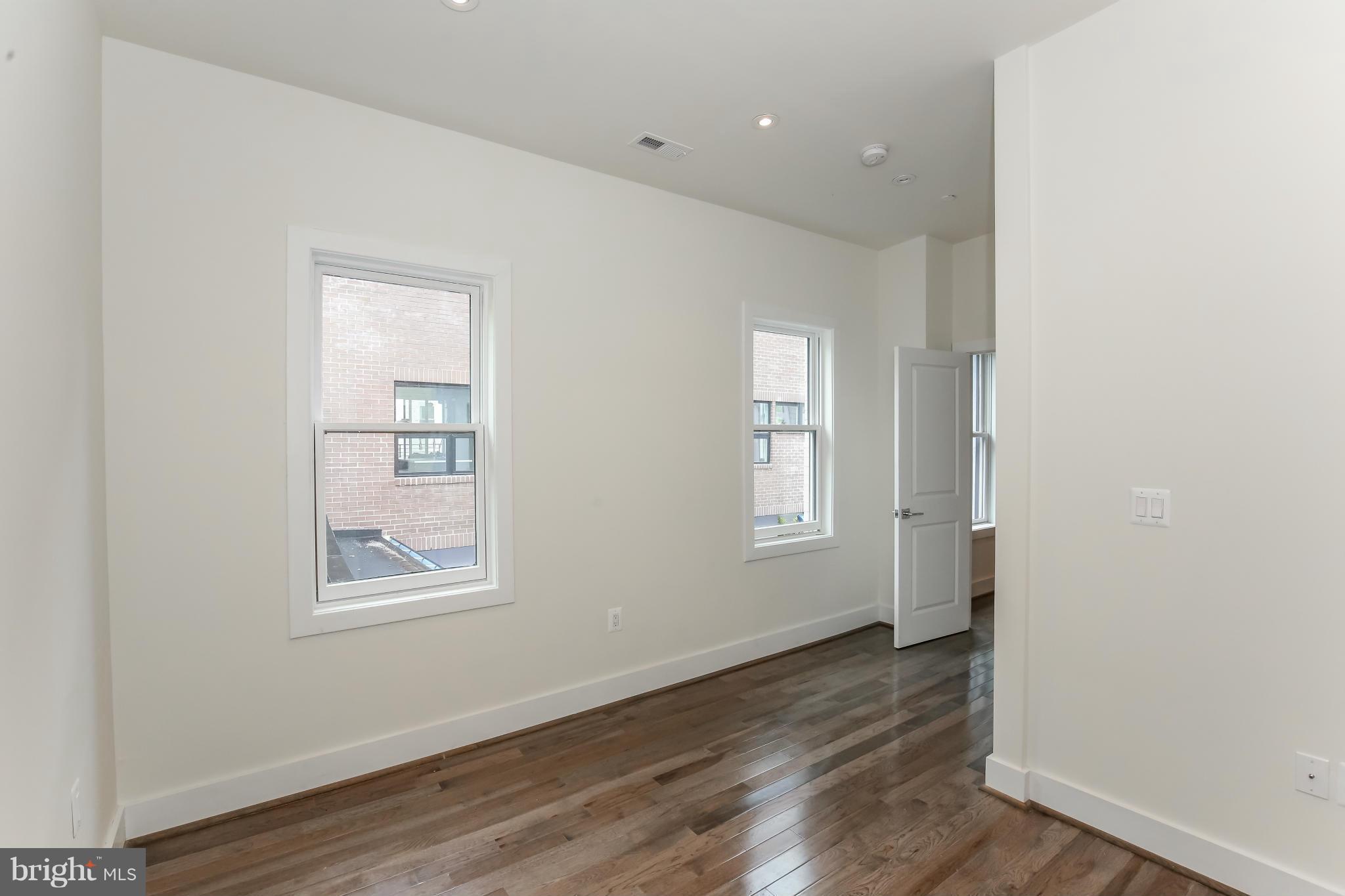 462 Ridge Street Northwest, Unit 3 Washington, DC 20001 - Photo 15 of 20 an empty room with wooden floor and windows