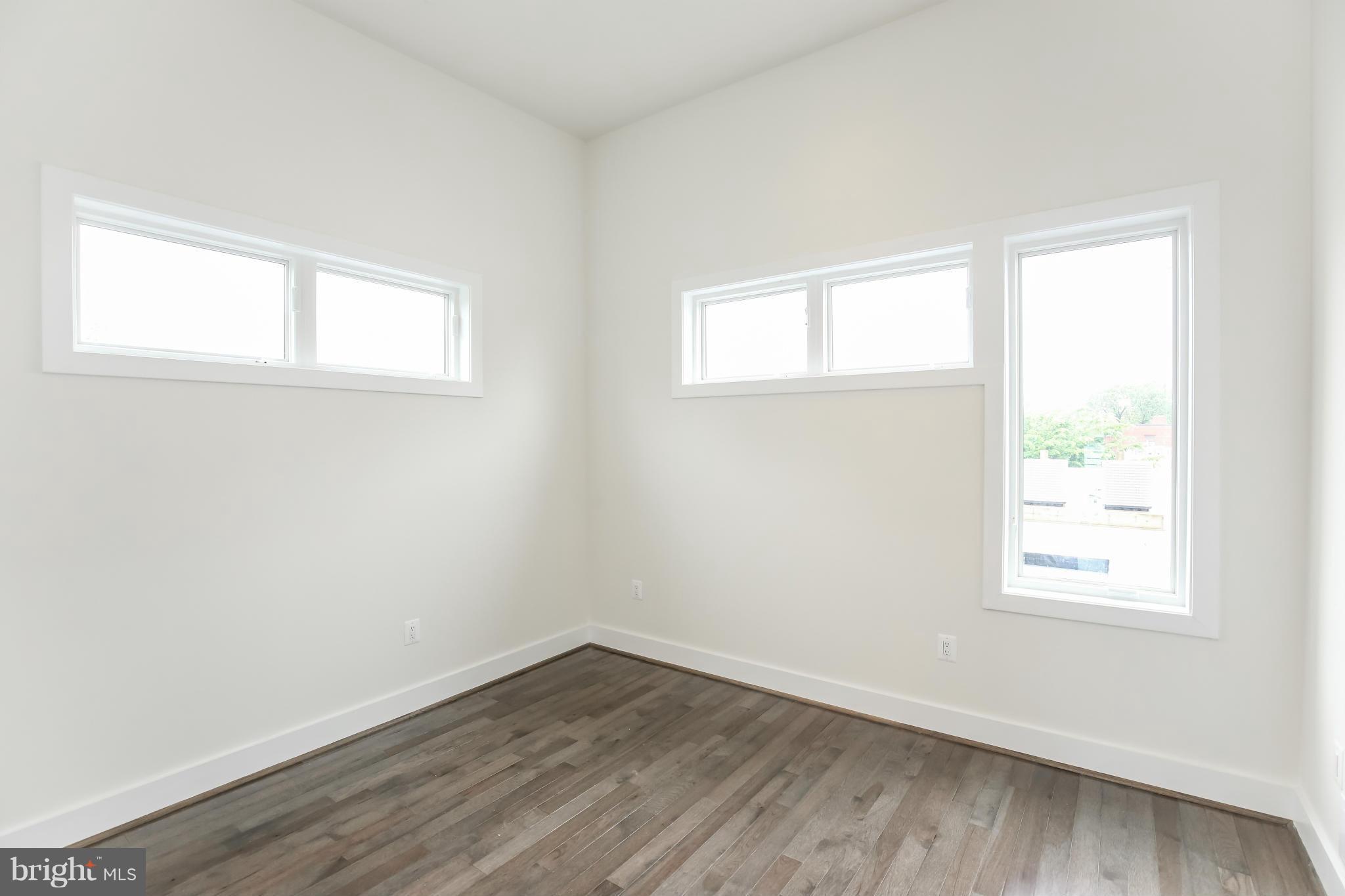 462 Ridge Street Northwest, Unit 3 Washington, DC 20001 - Photo 16 of 20 an empty room with wooden floor and windows