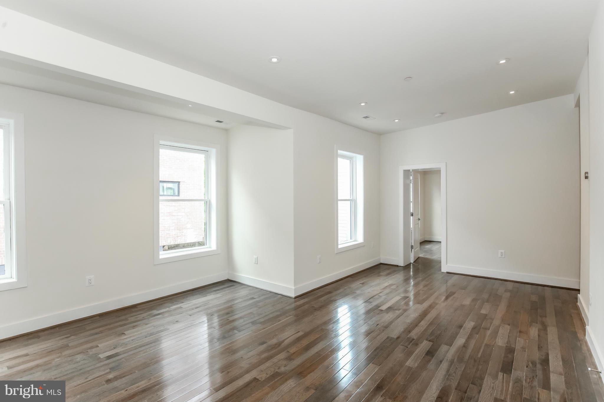 462 Ridge Street Northwest, Unit 3 Washington, DC 20001 - Photo 3 of 20 an empty room with wooden floor and windows