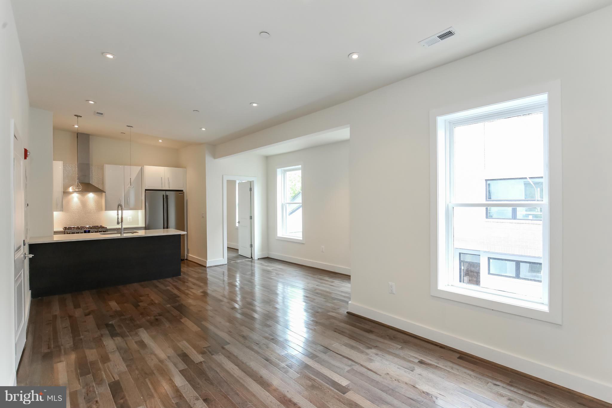 462 Ridge Street Northwest, Unit 3 Washington, DC 20001 - Photo 6 of 20 a view of kitchen with window and wooden floor
