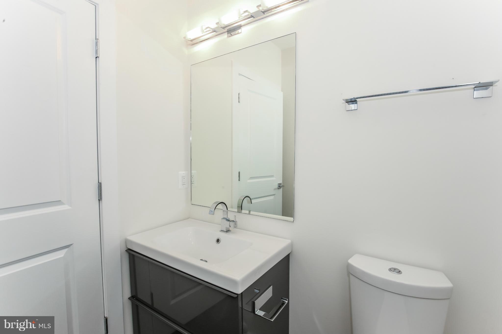 462 Ridge Street Northwest, Unit 3 Washington, DC 20001 - Photo 10 of 20 a bathroom with a sink a toilet and a mirror