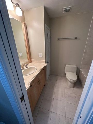 a bathroom with a sink a toilet a mirror and vanity