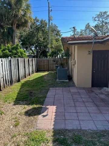 a view of a pathway with a wrought fence