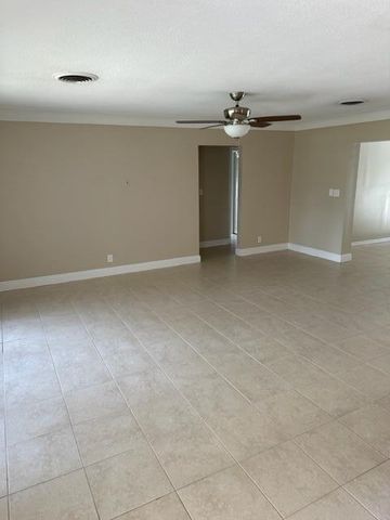 a view of a livingroom with a ceiling fan and entryway