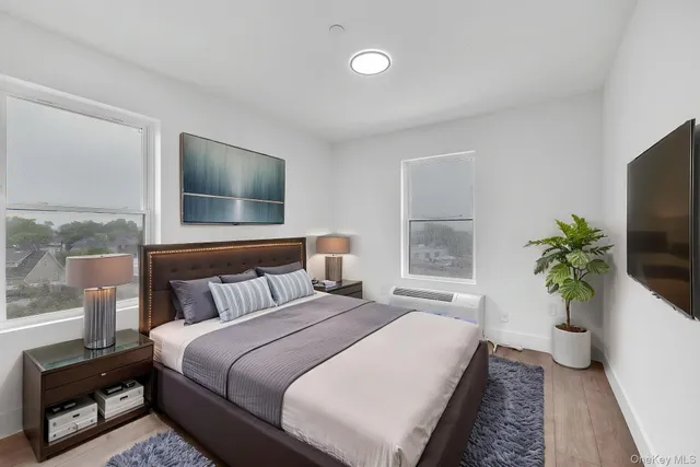 a bedroom with a bed and a flat screen tv