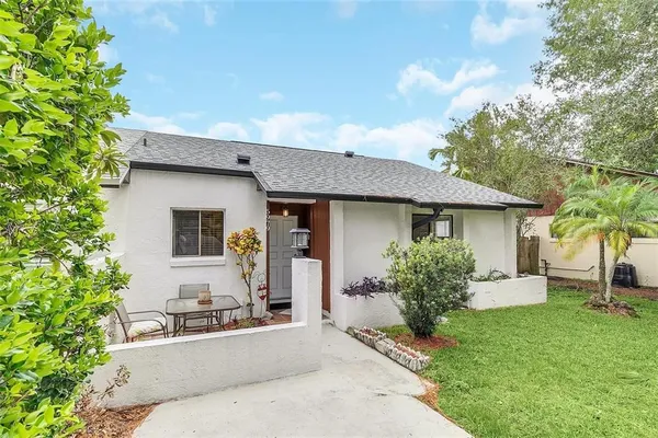 a house view with a sitting space and garden