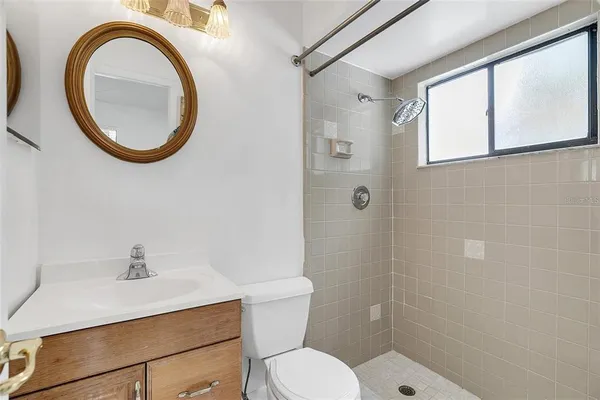 a bathroom with a sink a mirror and a toilet