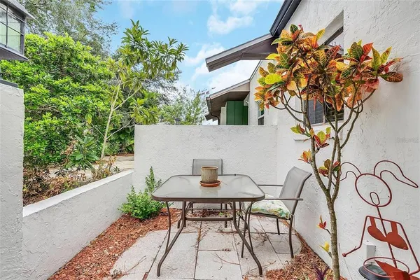 a backyard of a house with table and chairs