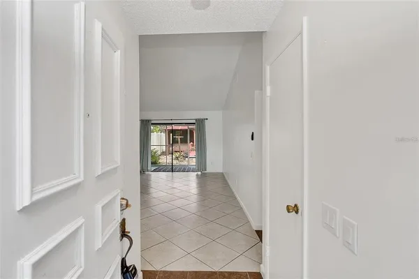 a view of a hallway with wooden floor and entryway
