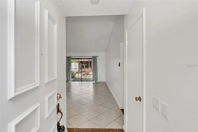 a view of a hallway with wooden floor and entryway