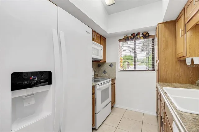 a kitchen with a stove and a refrigerator