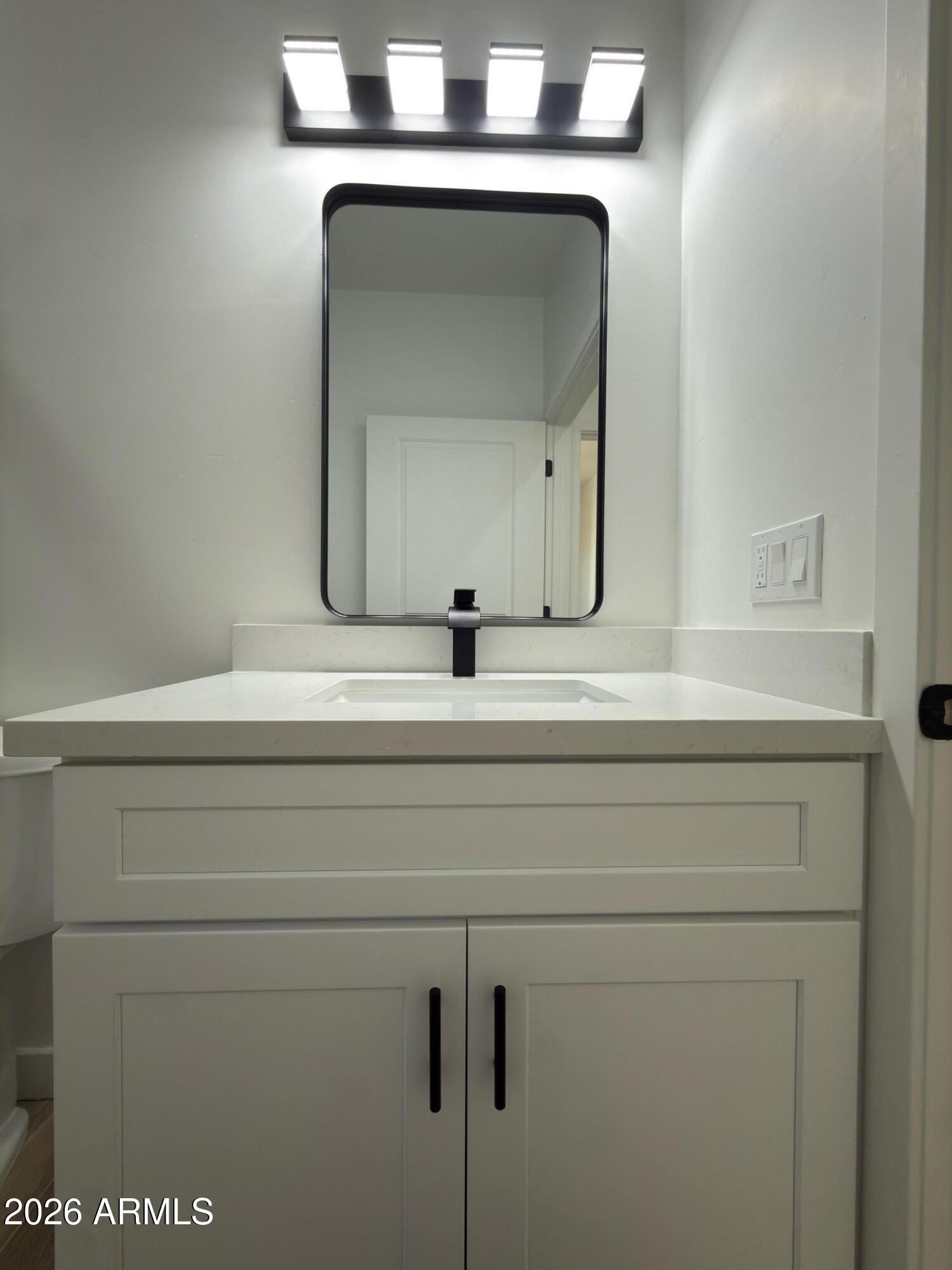 14199 South Diablo Road Arizona City, AZ 85123 - Photo 13 of 18 a bathroom with a sink mirror and vanity