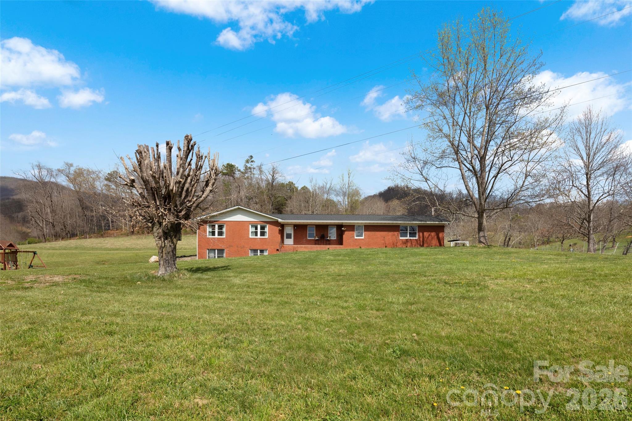 17 Boyd Cove Road Leicester, NC 28748 - Photo 2 of 40 a white house with a big yard and large trees