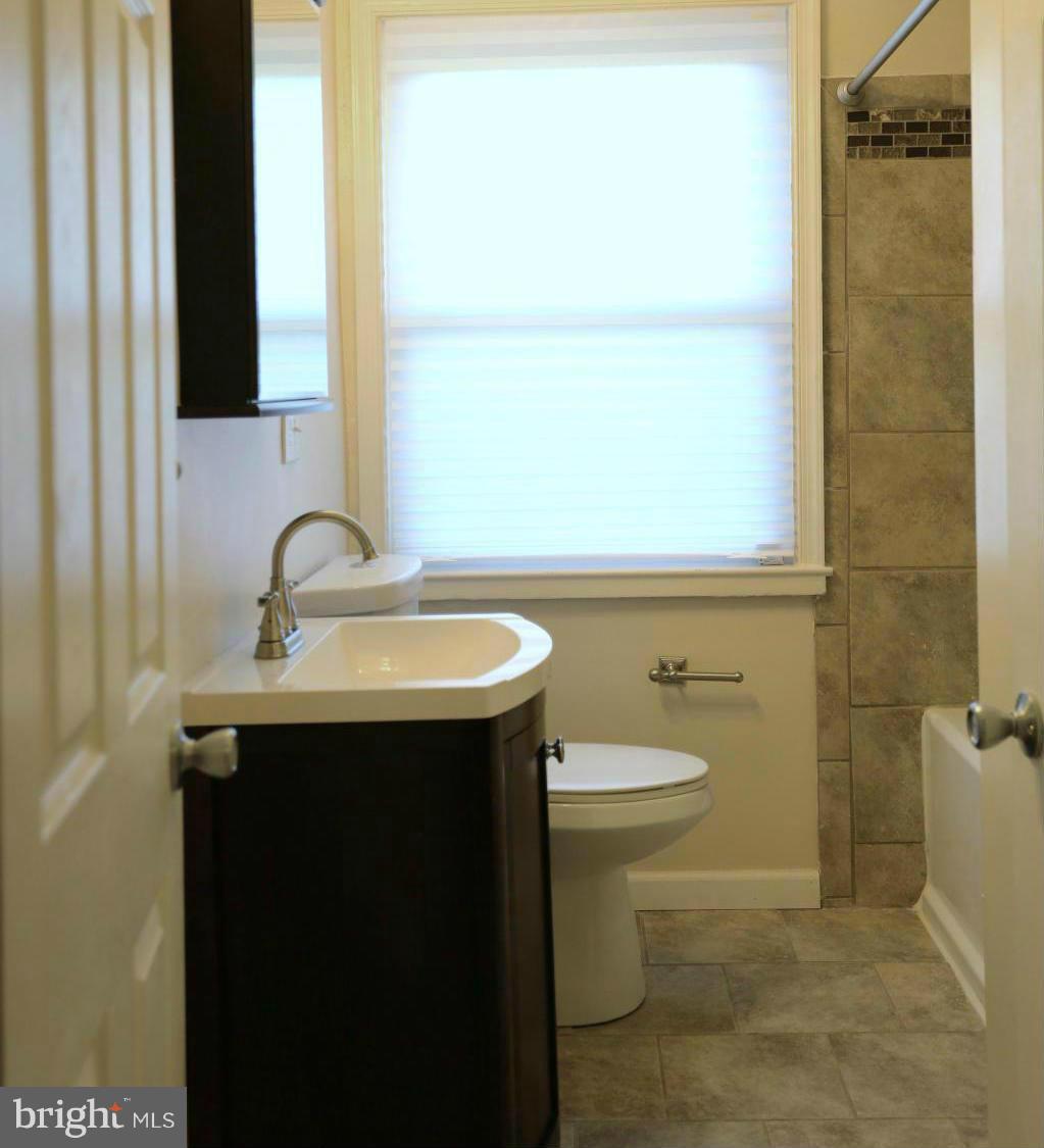 5222 Kelway Road Baltimore, MD 21239 - Photo 14 of 25 a bathroom with a sink and a mirror