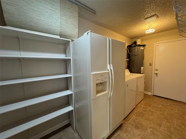 a utility room with wooden floor washer and dryer