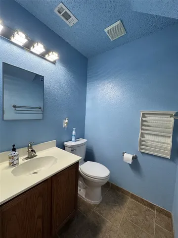 a bathroom with a sink toilet and mirror