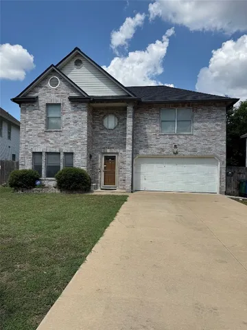 a large tree in front of a house