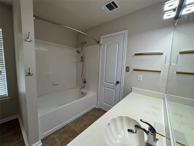 a spacious bathroom with a tub and shower