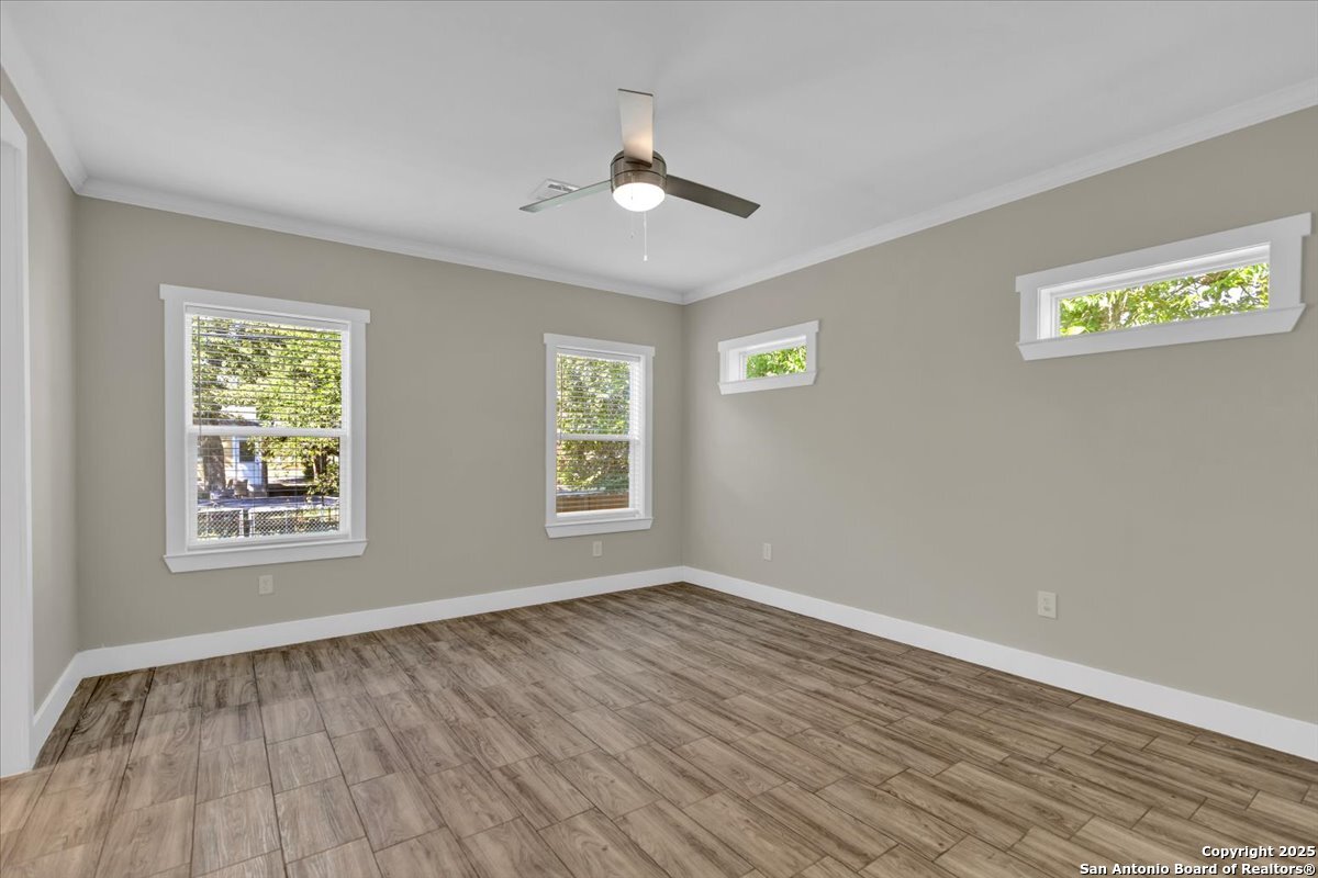 611 Rudolph San Antonio, TX 78202 - Photo 11 of 25 a view of an empty room with wooden floor and a window