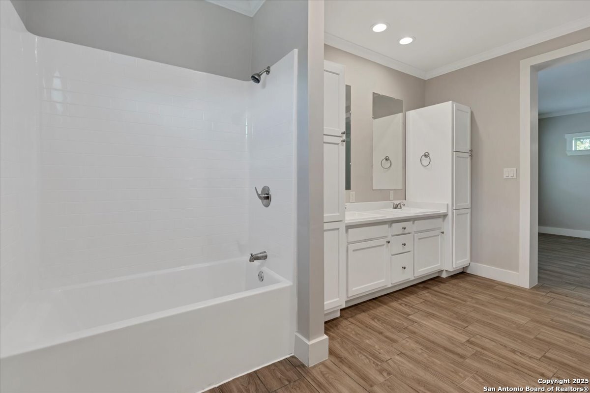 611 Rudolph San Antonio, TX 78202 - Photo 13 of 25 a bathroom with a tub sink double vanity and a shower