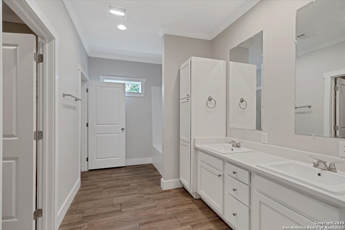 611 Rudolph San Antonio, TX 78202 - Photo 14 of 25 a spacious bathroom with double vanity and mirrors