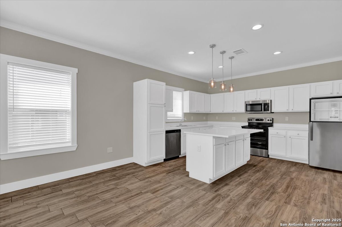 611 Rudolph San Antonio, TX 78202 - Photo 3 of 25 a kitchen with granite countertop a refrigerator and a stove top oven