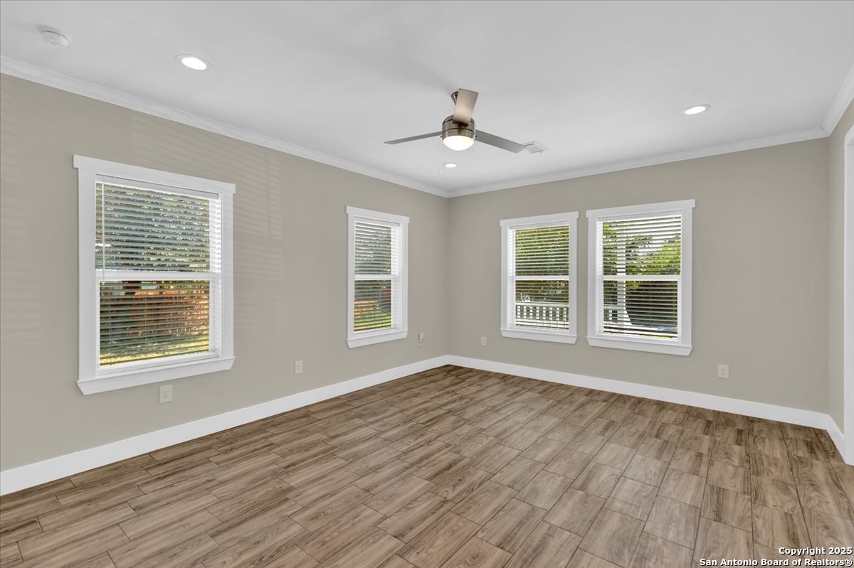 611 Rudolph San Antonio, TX 78202 - Photo 8 of 25 a view of an empty room with wooden floor and a window