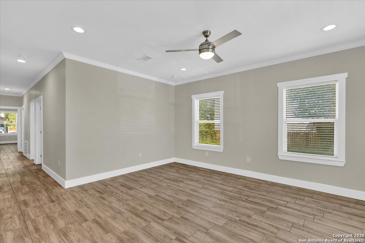 611 Rudolph San Antonio, TX 78202 - Photo 10 of 25 a view of an empty room with wooden floor and a window