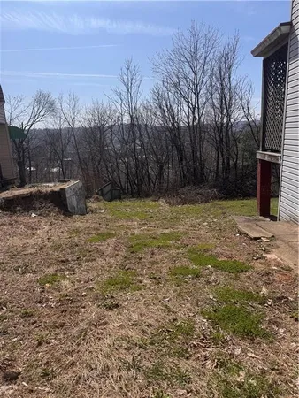 a view of a backyard with wooden fence