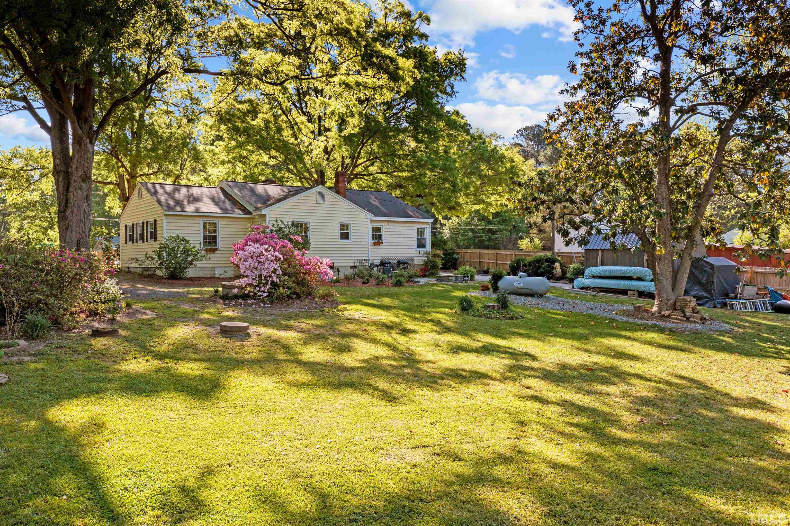 5100 Clearview Street Raleigh, NC 27603 - Photo 11 of 36 a front view of a house with swimming pool and trees