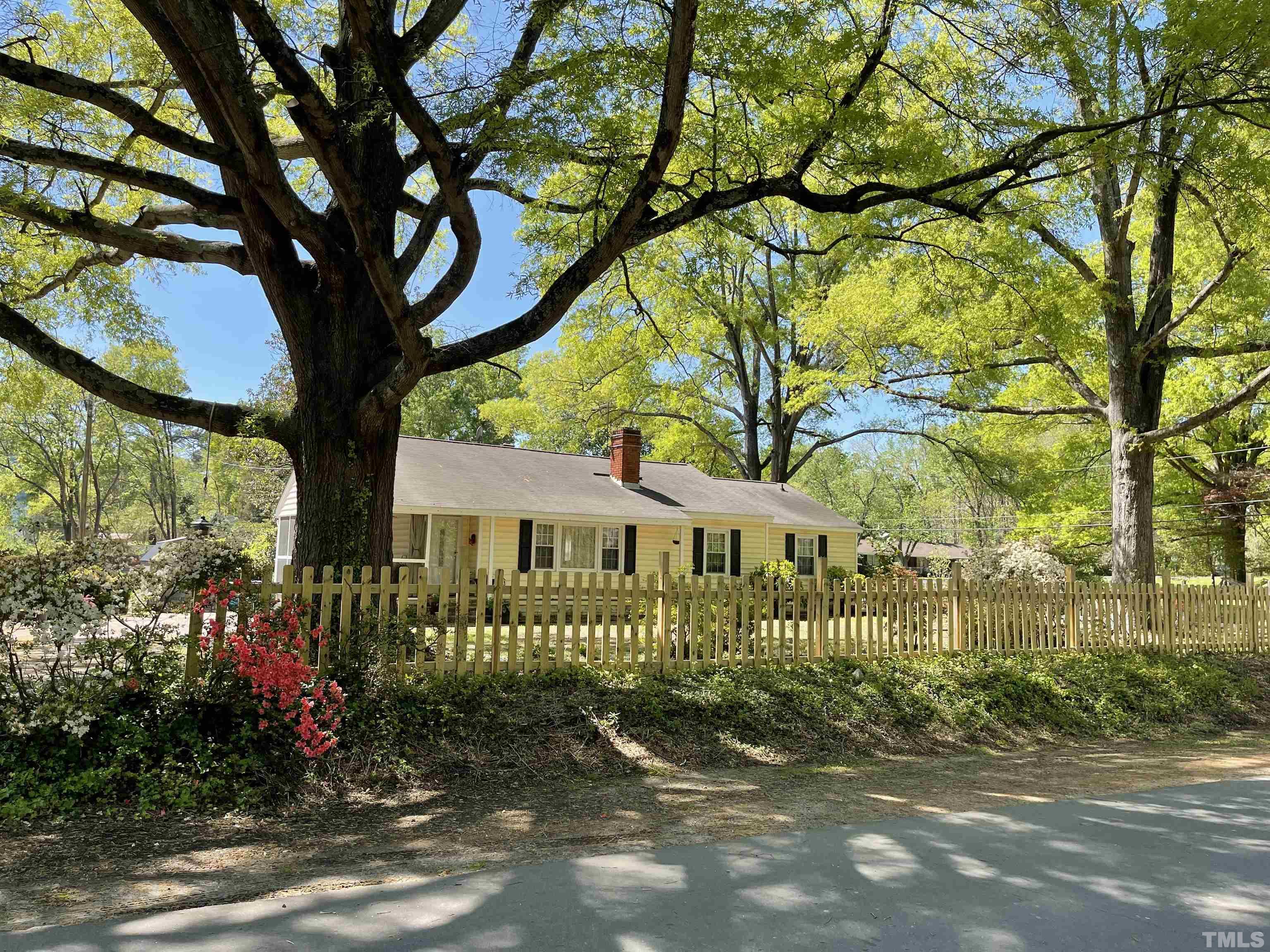 5100 Clearview Street Raleigh, NC 27603 - Photo 2 of 36 a front view of a house with a garden