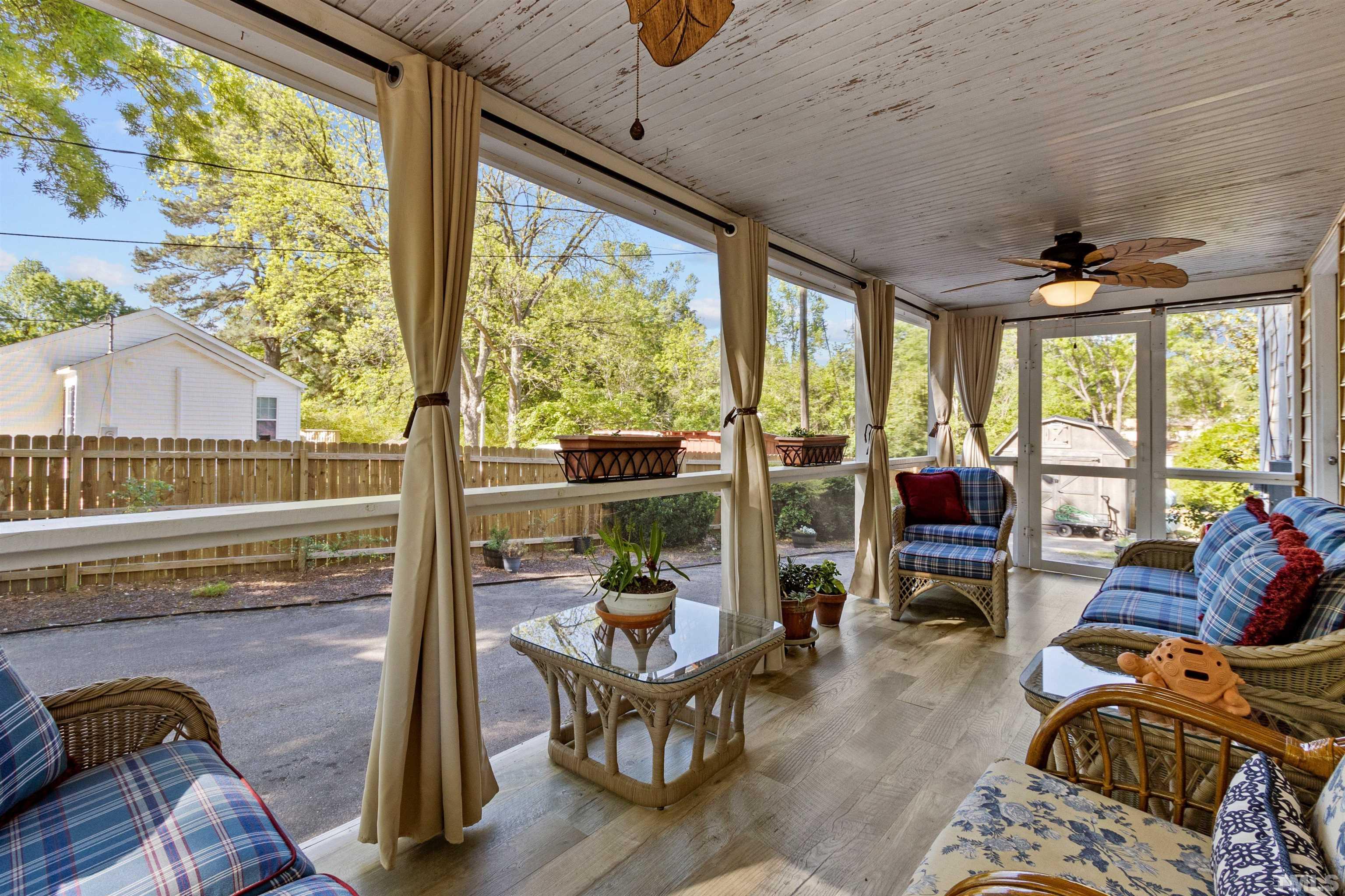 5100 Clearview Street Raleigh, NC 27603 - Photo 22 of 36 a living room with furniture and floor to ceiling windows