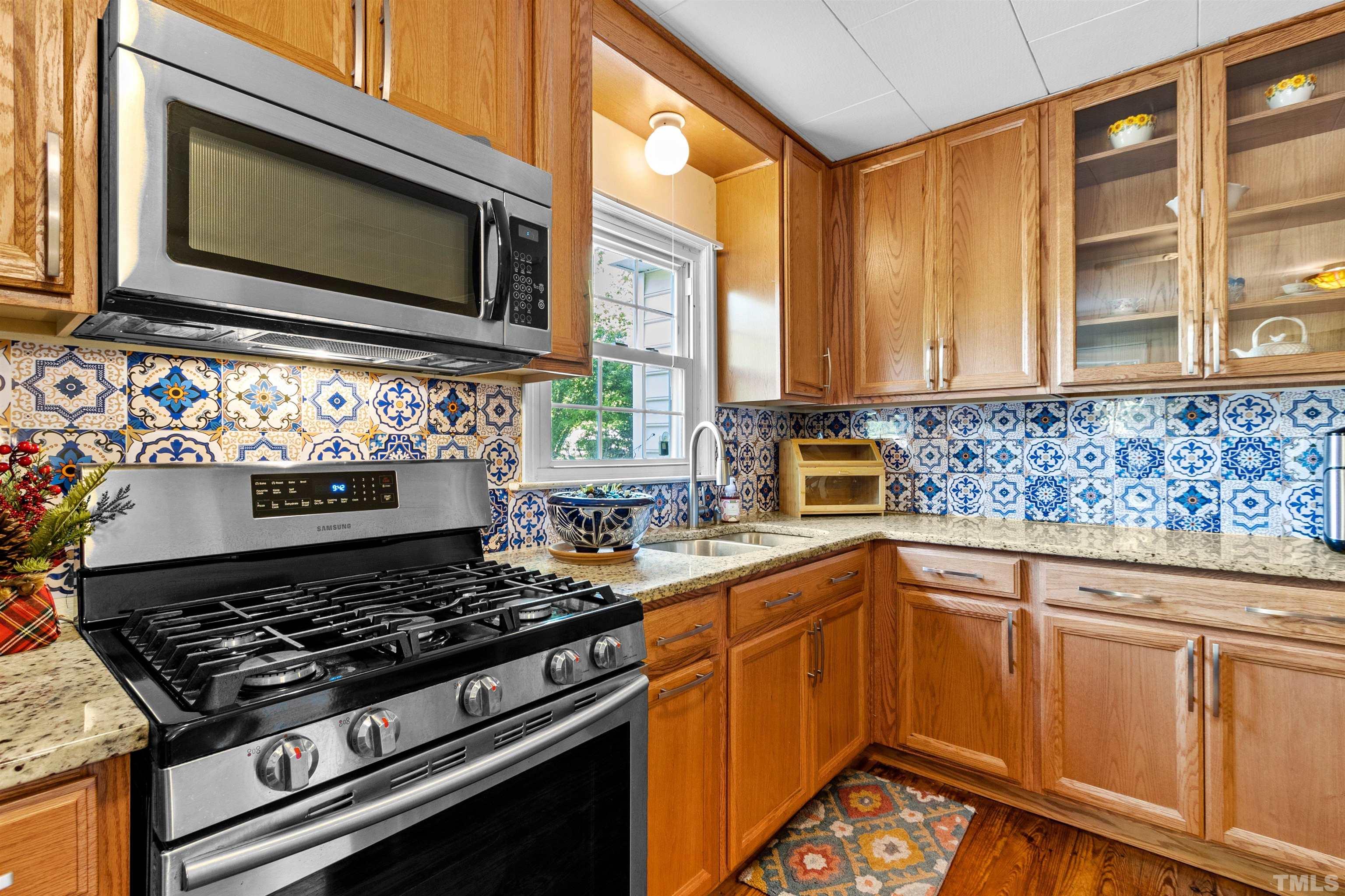 5100 Clearview Street Raleigh, NC 27603 - Photo 26 of 36 a kitchen with stainless steel appliances a stove sink and microwave