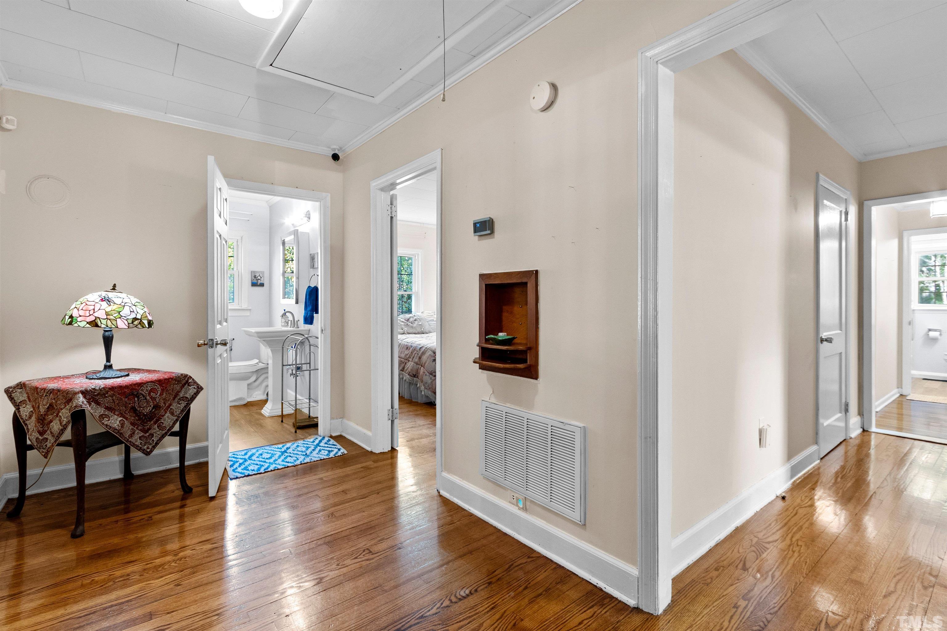 5100 Clearview Street Raleigh, NC 27603 - Photo 31 of 36 a view of a livingroom with wooden floor and a ceiling fan