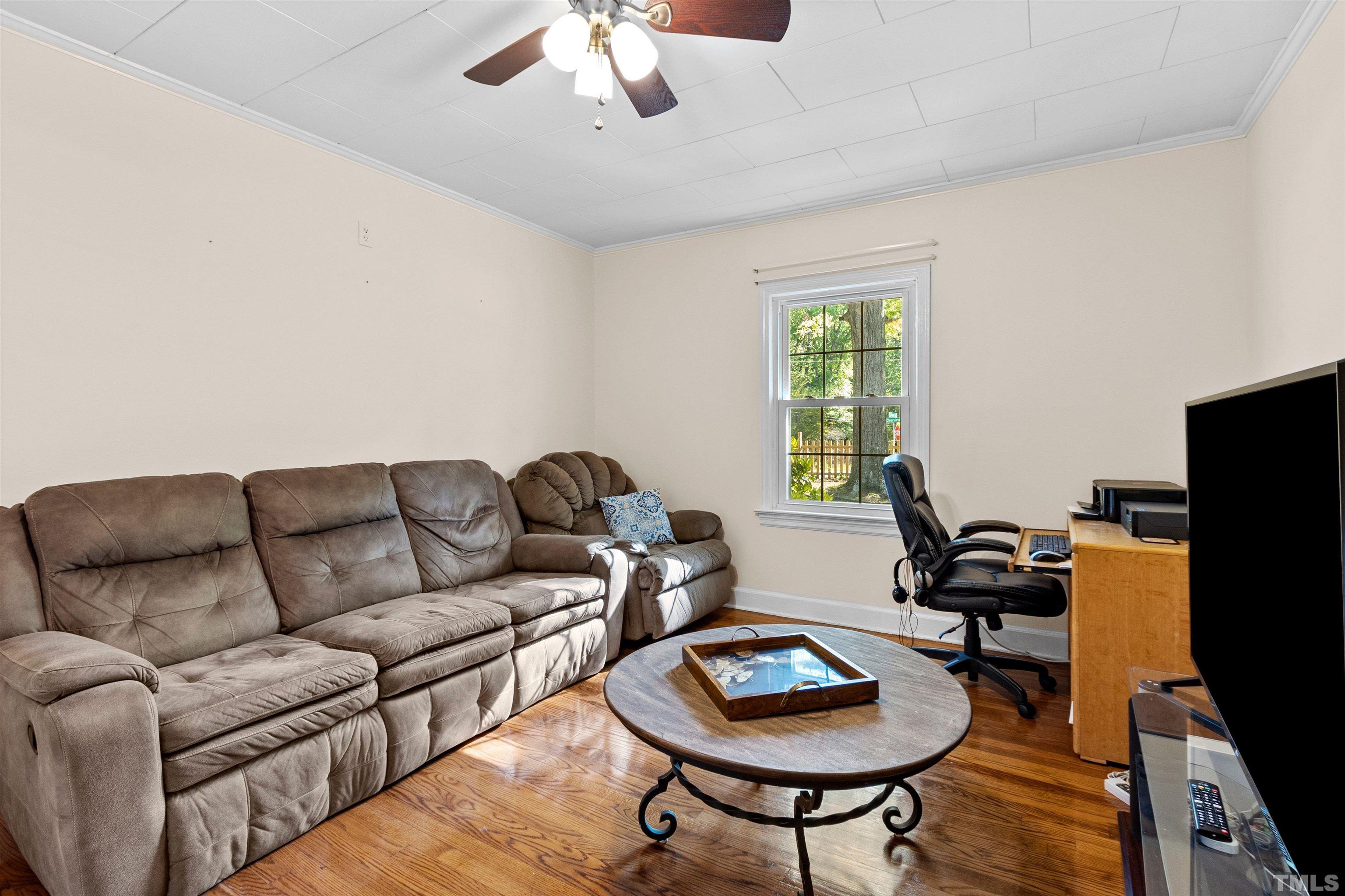 5100 Clearview Street Raleigh, NC 27603 - Photo 34 of 36 a living room with furniture and a flat screen tv