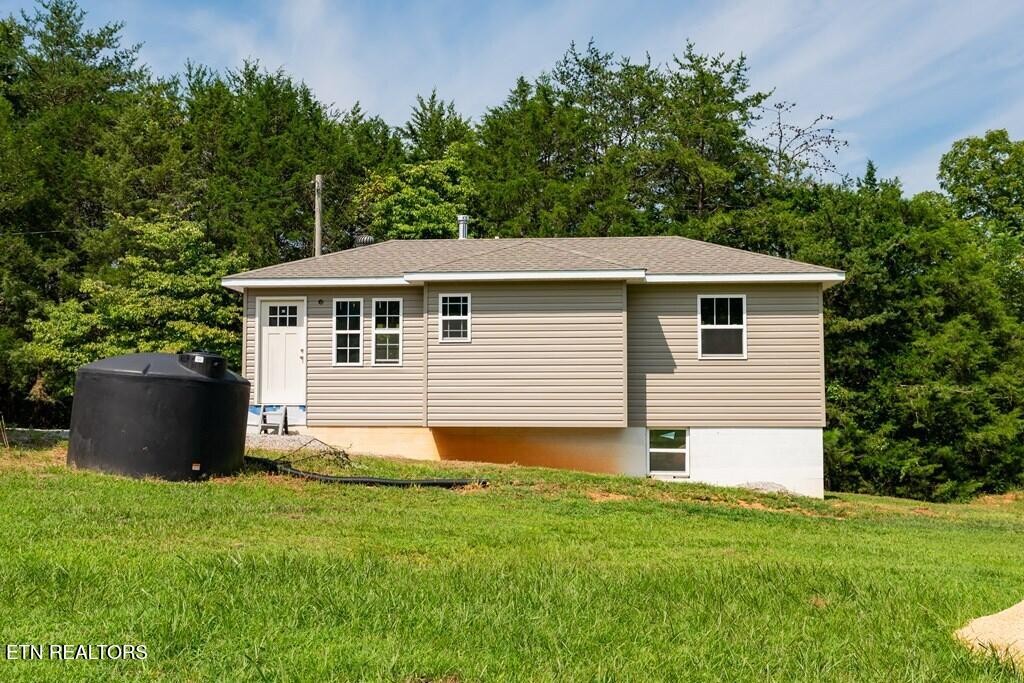 1518 Cummingsville And Sparkman Road Doyle, TN 38559 - Photo 49 of 58 a front view of a house with a garden
