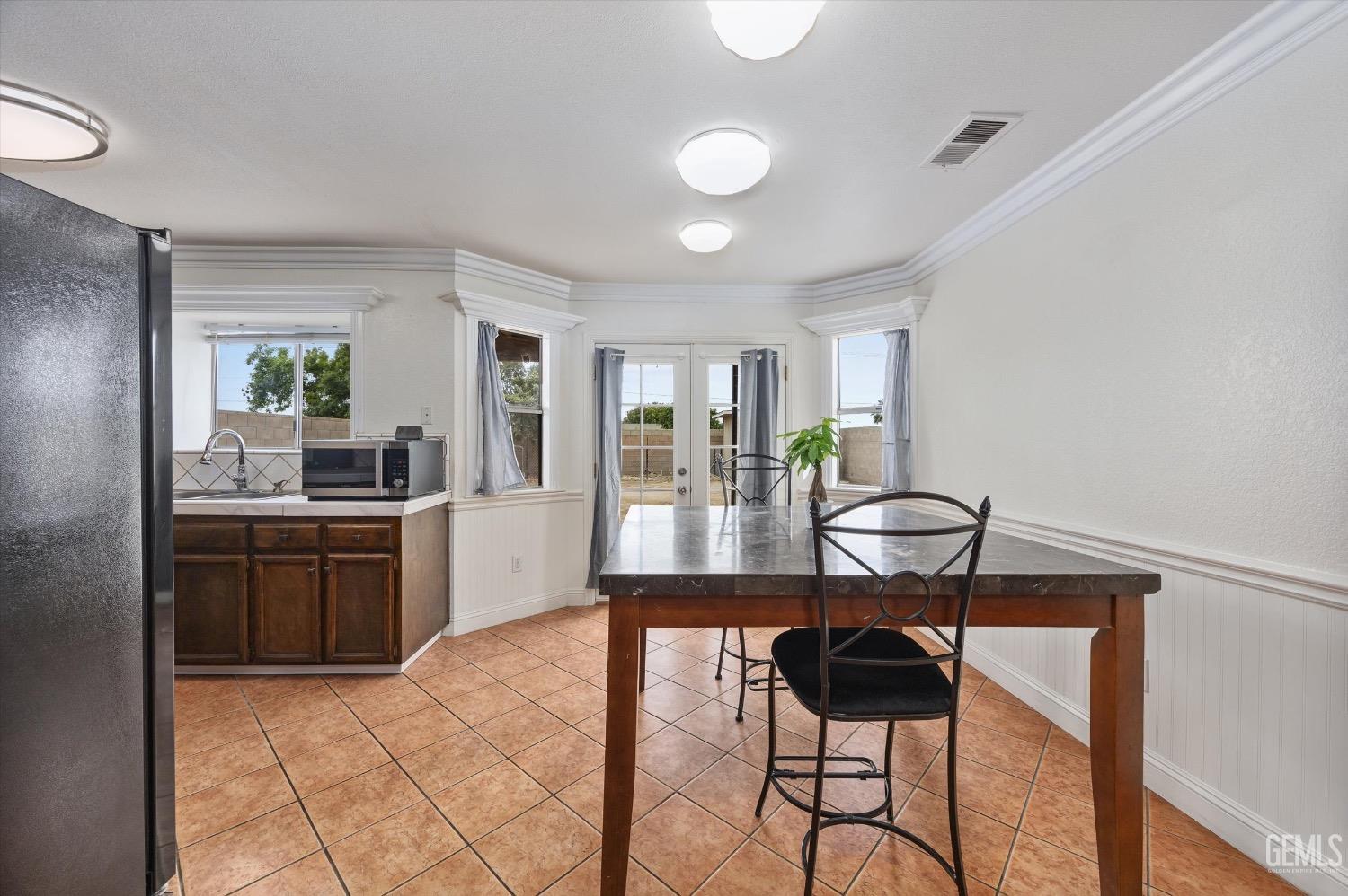 Undisclosed Address Bakersfield, CA 93307 - Photo 15 of 47 a kitchen with stainless steel appliances kitchen island granite countertop a stove a sink and a refrigerator