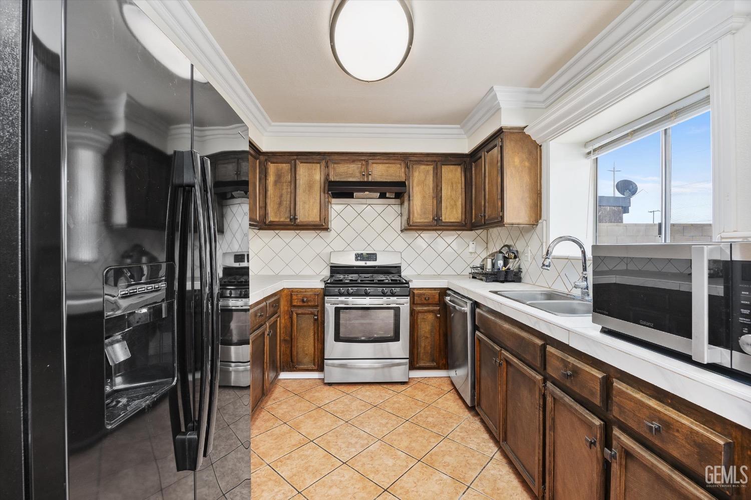 Undisclosed Address Bakersfield, CA 93307 - Photo 17 of 47 a kitchen with stainless steel appliances granite countertop a stove and a sink