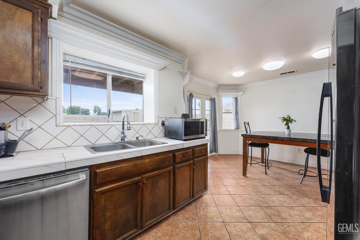 Undisclosed Address Bakersfield, CA 93307 - Photo 20 of 47 a kitchen with a sink and cabinets