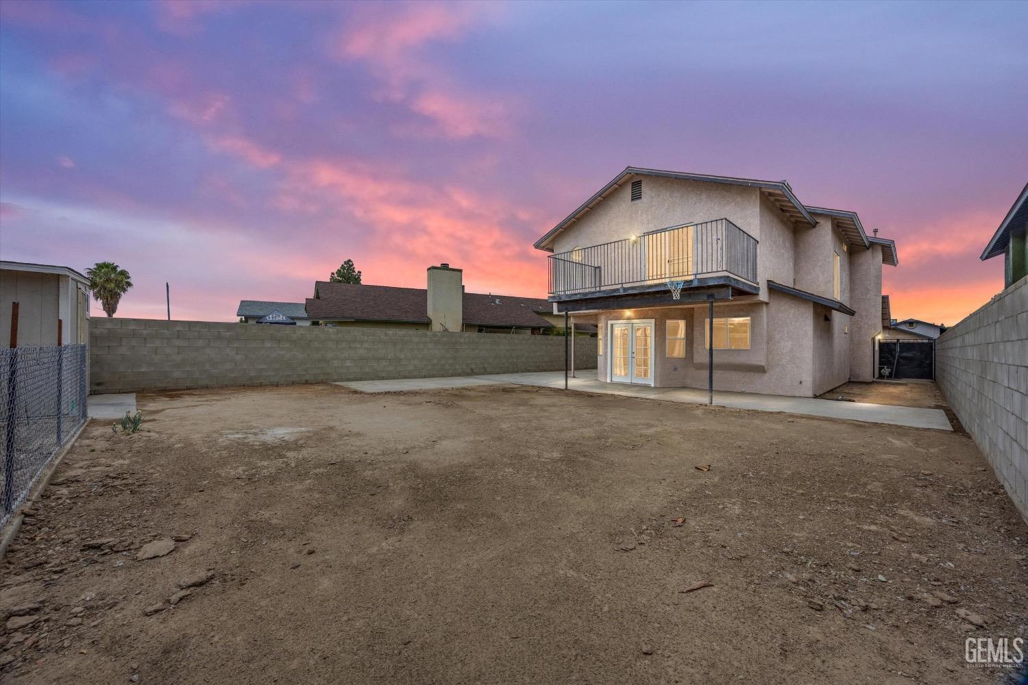 Undisclosed Address Bakersfield, CA 93307 - Photo 2 of 47 a front view of a house with a yard