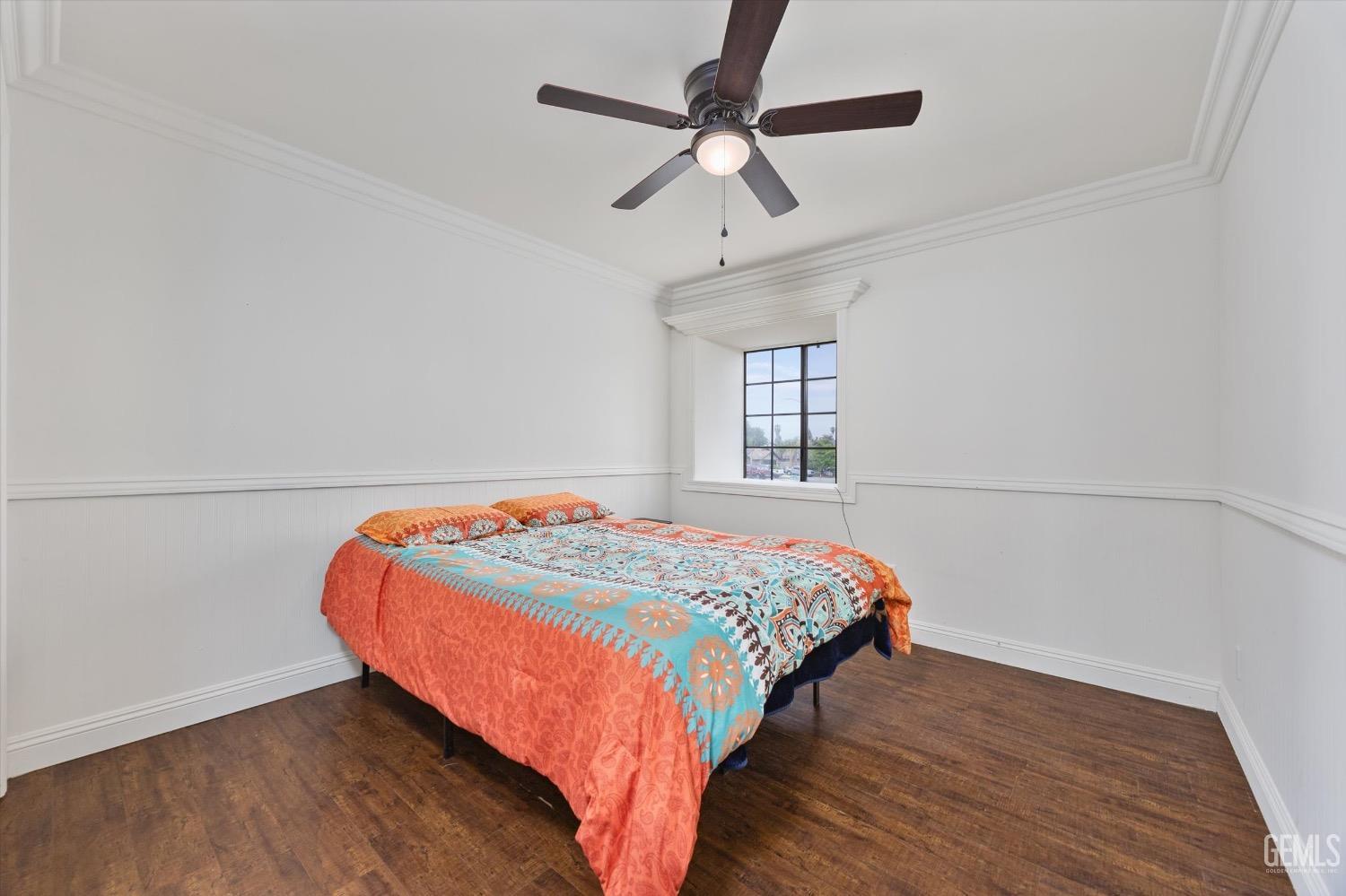 Undisclosed Address Bakersfield, CA 93307 - Photo 31 of 47 a bedroom with a bed and a chandelier