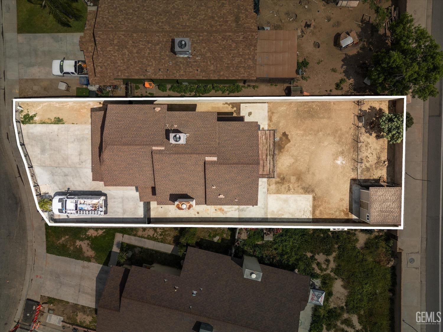 Undisclosed Address Bakersfield, CA 93307 - Photo 45 of 47 an aerial view of a residential apartment building with a yard and seating space