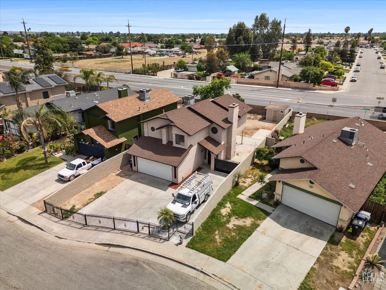 Undisclosed Address Bakersfield, CA 93307 - Photo 5 of 47 an aerial view of a house with a yard and lake view