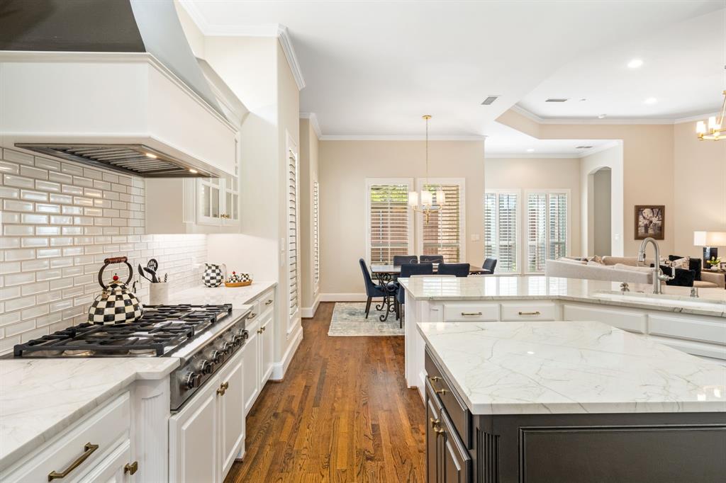 5116 Meadowside Lane Plano, TX 75093 - Photo 11 of 36 a kitchen with a stove and a wooden floors