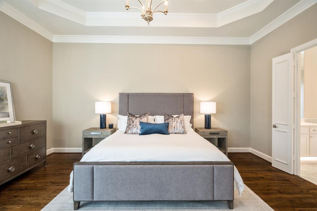5116 Meadowside Lane Plano, TX 75093 - Photo 14 of 36 a bedroom with a bed and wooden floor