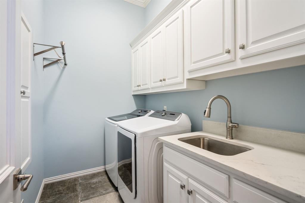 5116 Meadowside Lane Plano, TX 75093 - Photo 27 of 36 a view of a kitchen with sink and washing machine